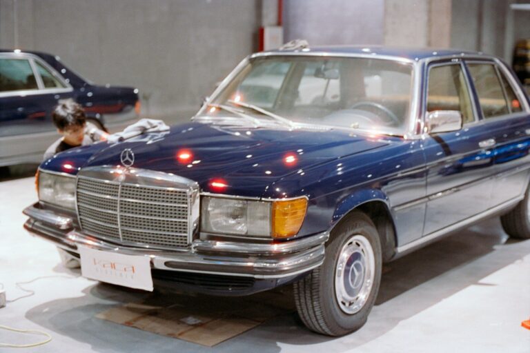 A vintage dark blue mercedes-benz sedan
